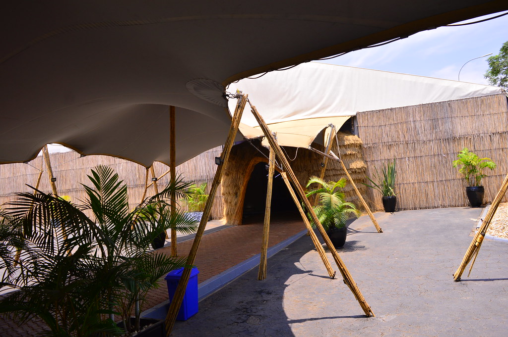 Conference presentation with large screens and audience in theater seating